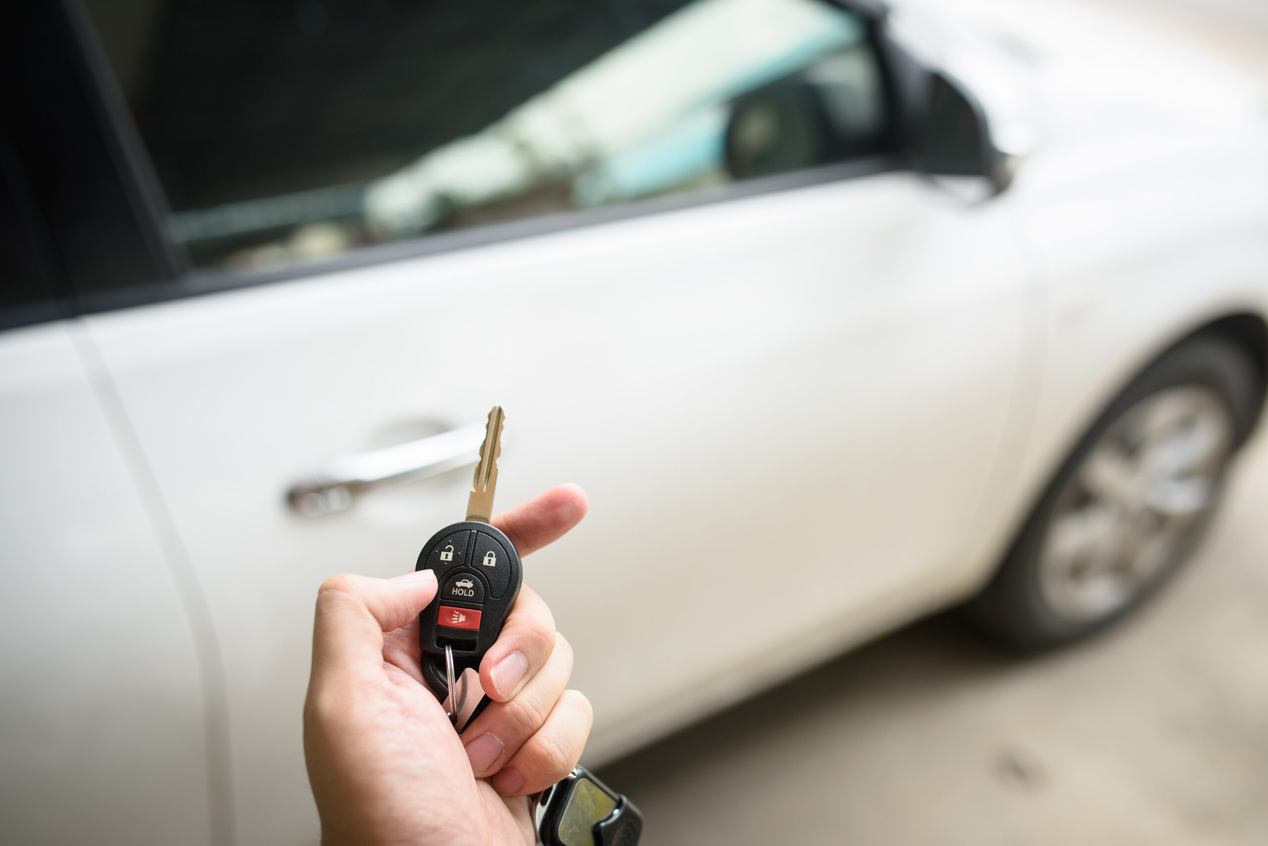 Men's hand presses on the remote control car unlock systems